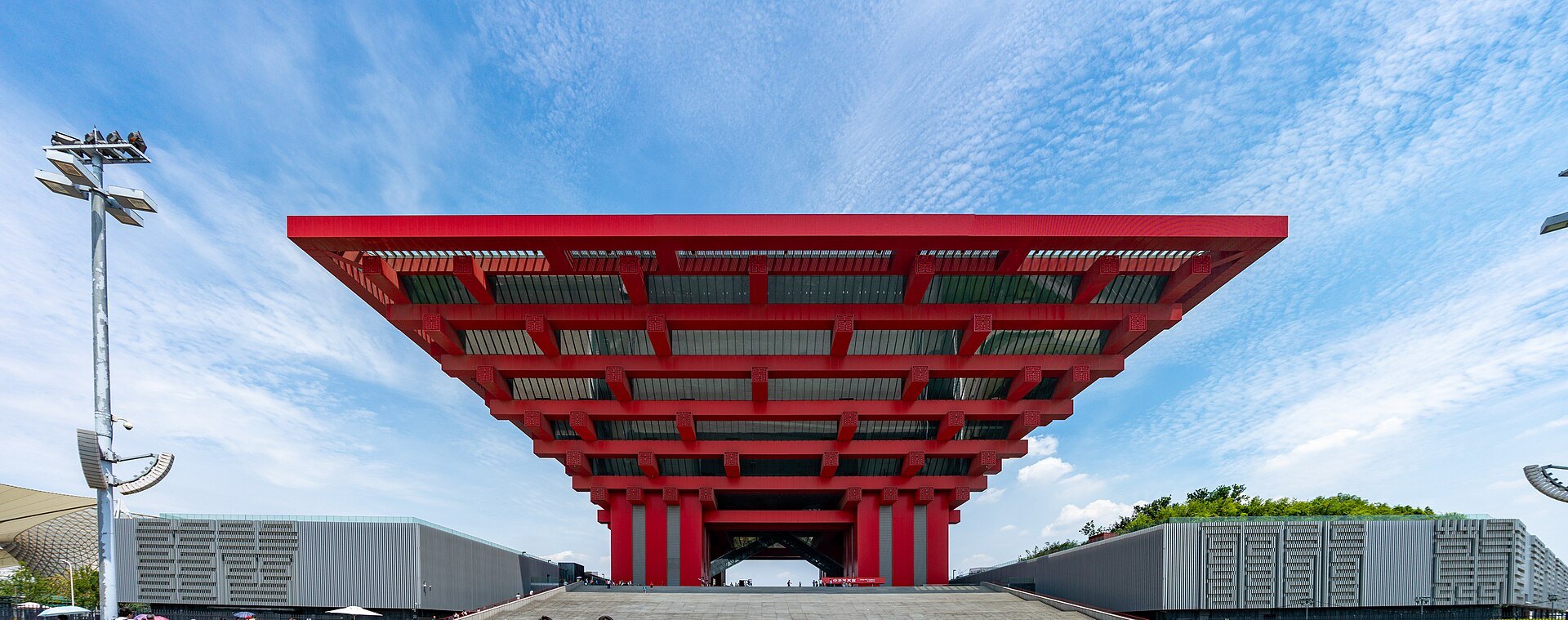 The inverted red timber-bracket form of the China Art Museum under a clear sky