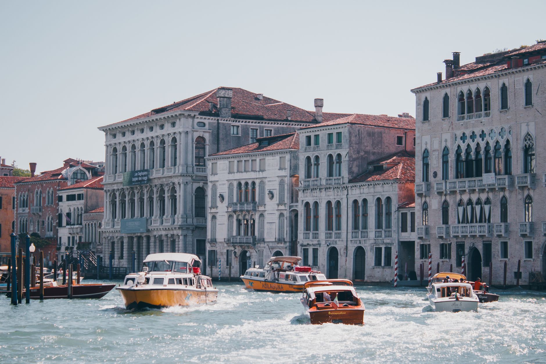 Boats navigate the historic Grand Canal in Venice, surrounded by architecture