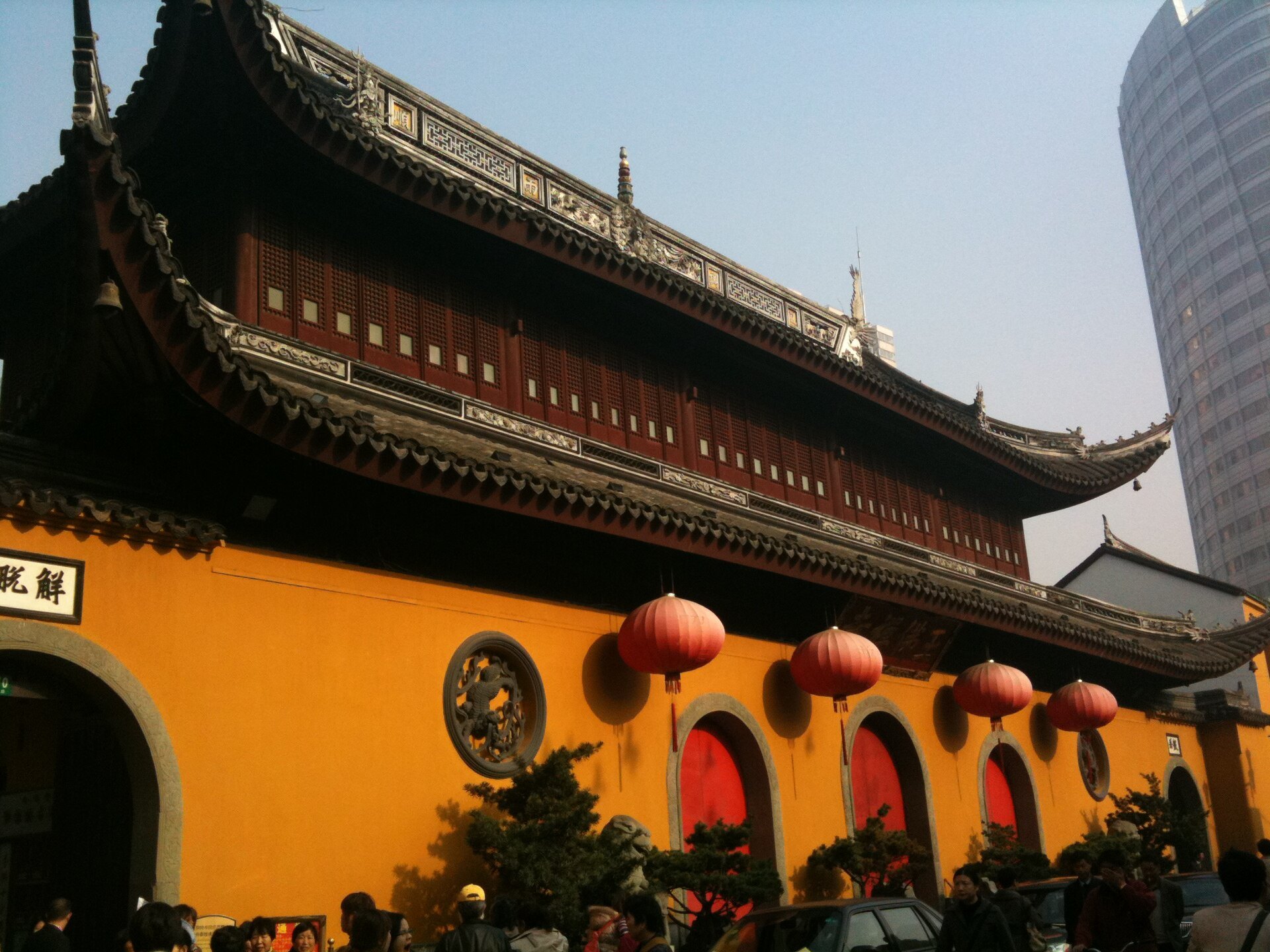 The yellow outer wall of the Jade Buddha Temple hung with red lanterns
