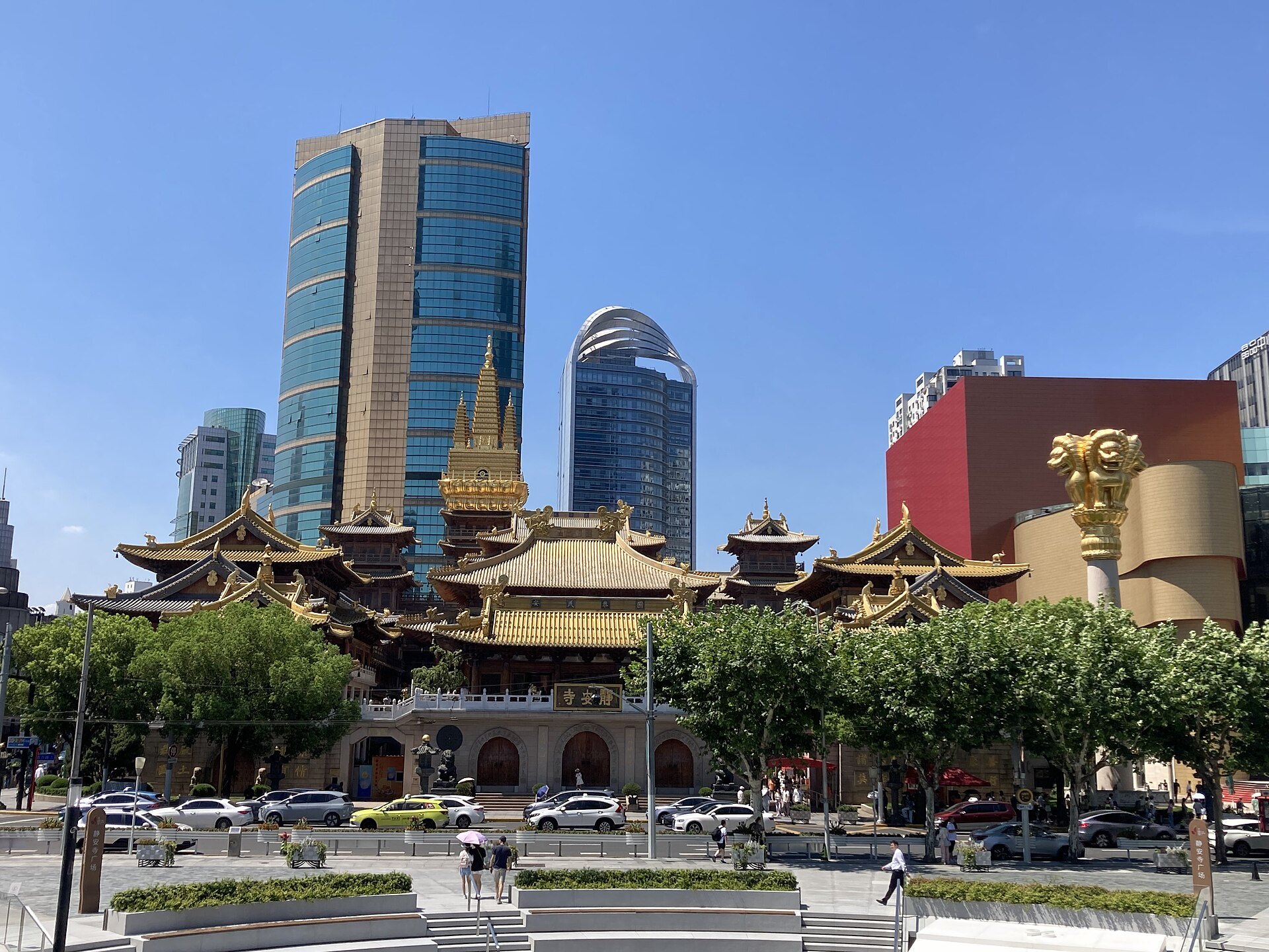 Jing'an Temple seen from the street with high-rises on both sides