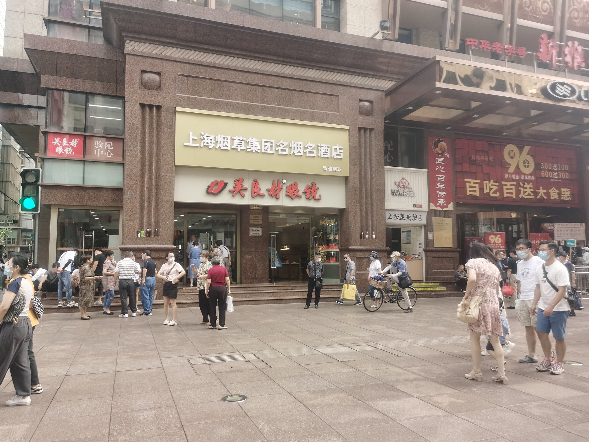 A crowded shopfront on East Nanjing Road with people passing