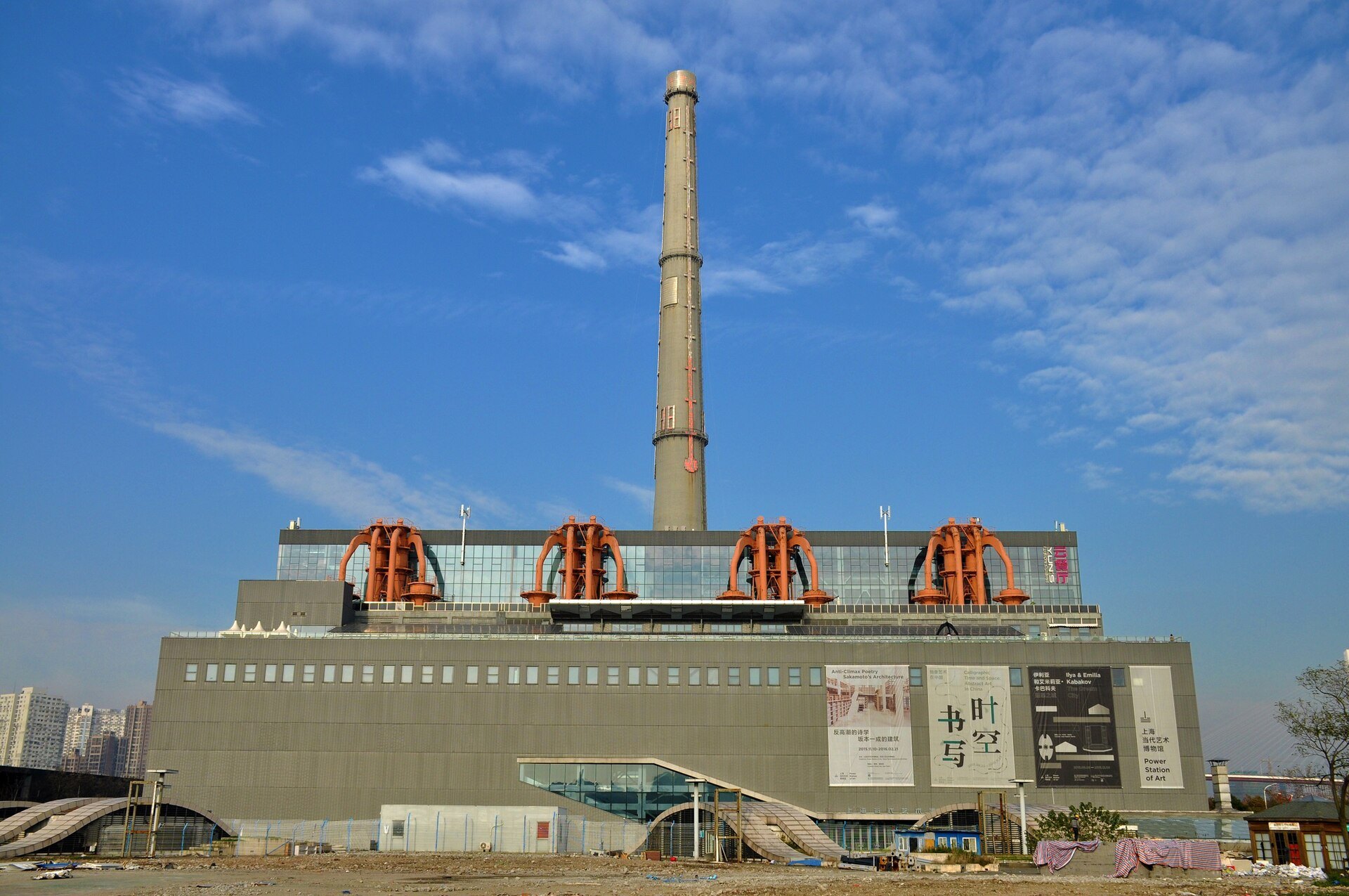 The single tall chimney of the former Nanshi power plant against a blue sky