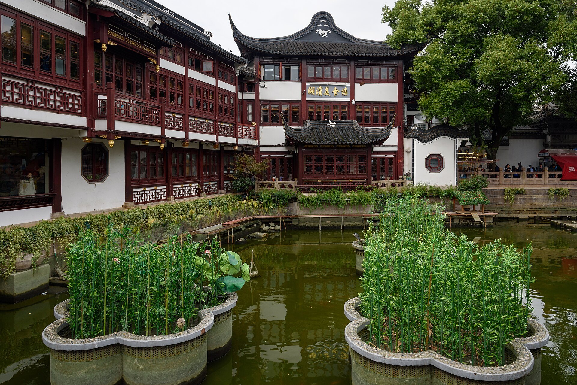A pavilion and its reflection in the pond at the Yu Garden