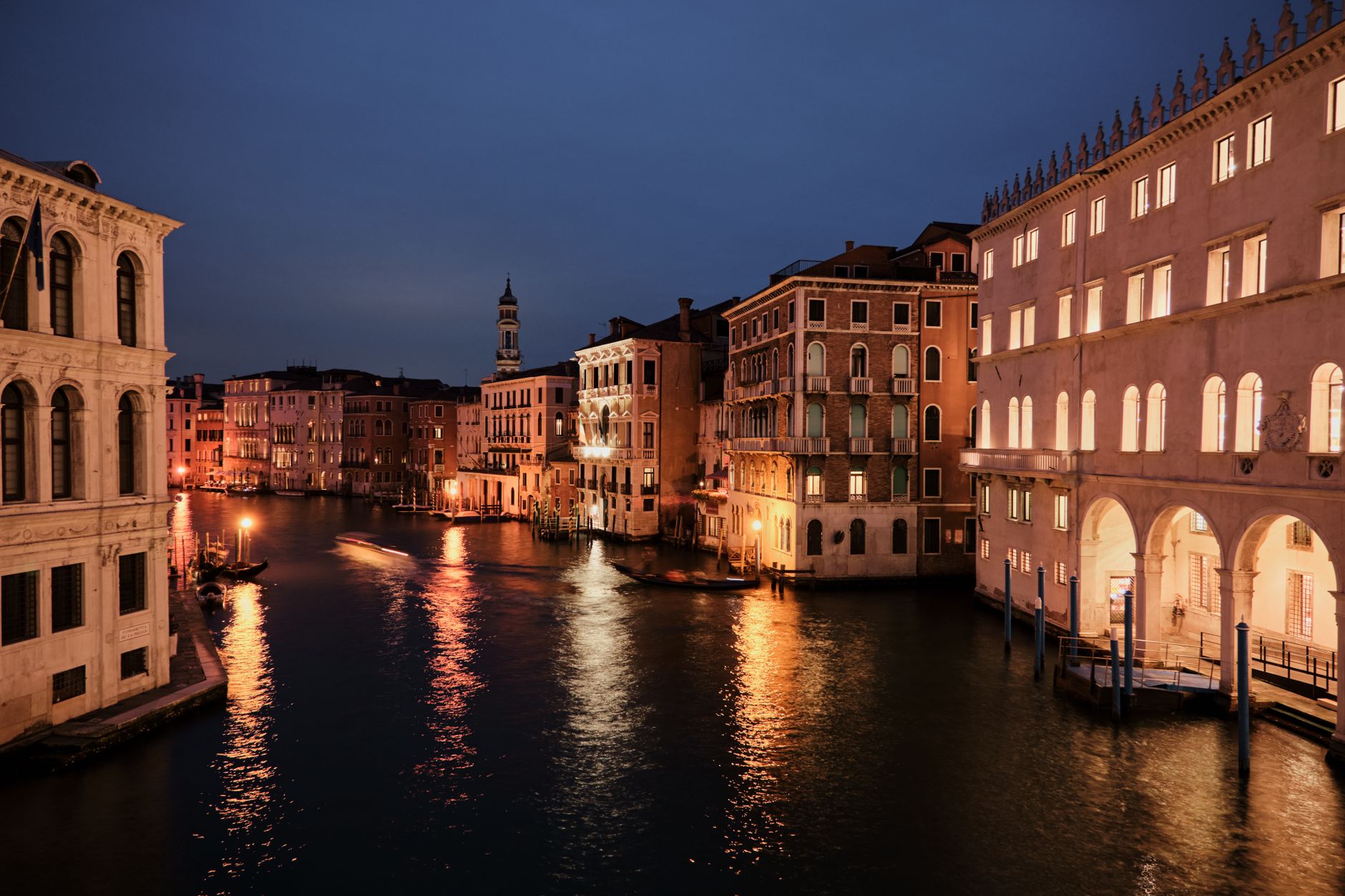 Venice's Grand Canal with illuminated buildings reflecting on water