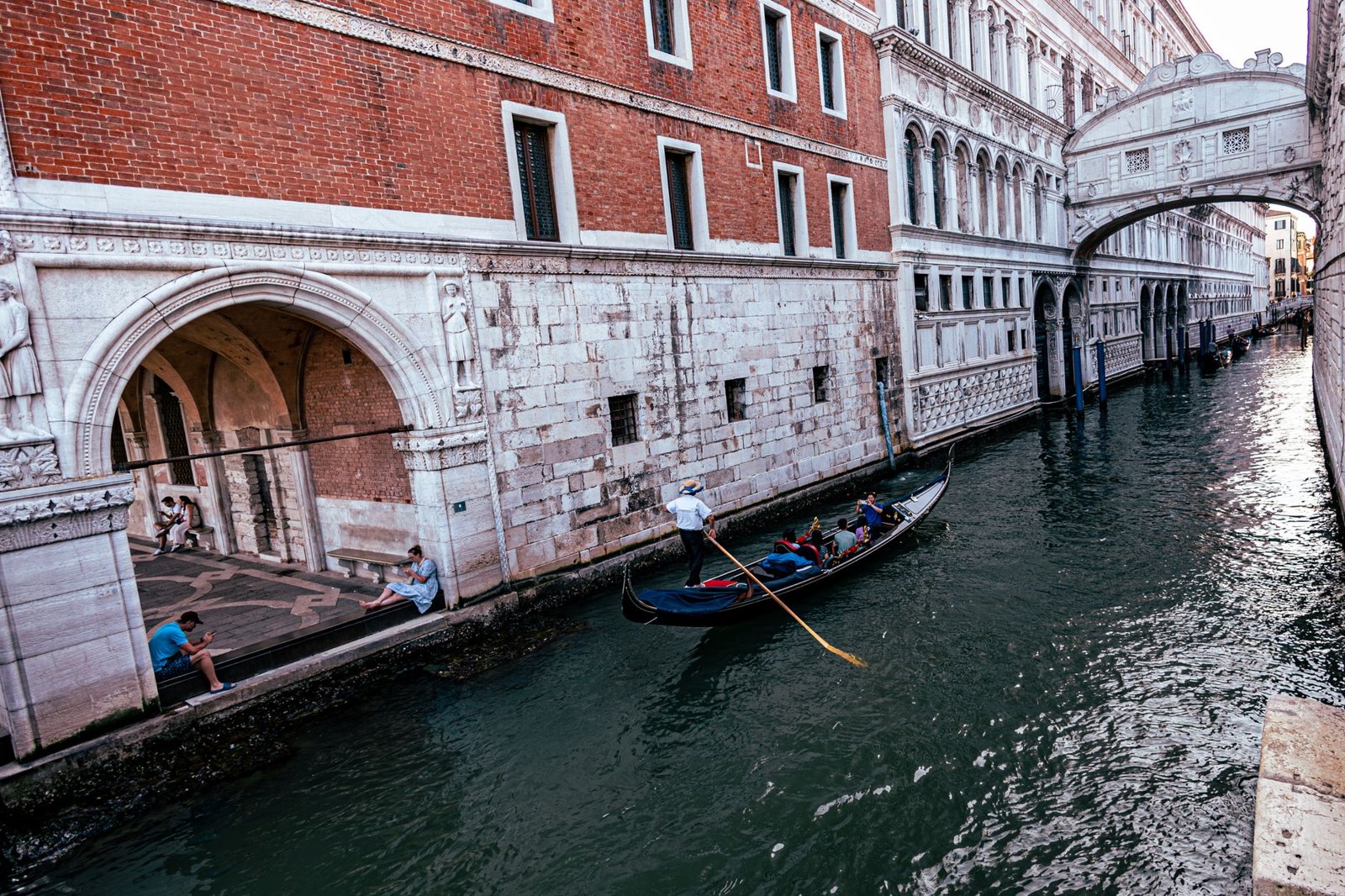Gondola glides under the historic Bridge of Sighs in Venice, capturing the essence of Italian beauty and architecture