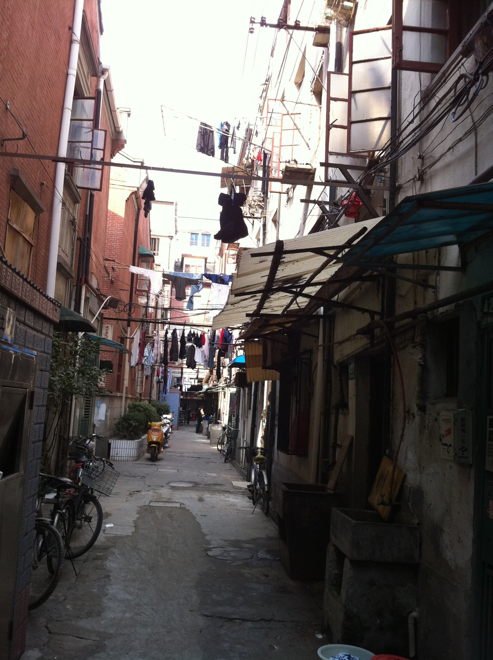 A narrow back lane between lane-house terraces