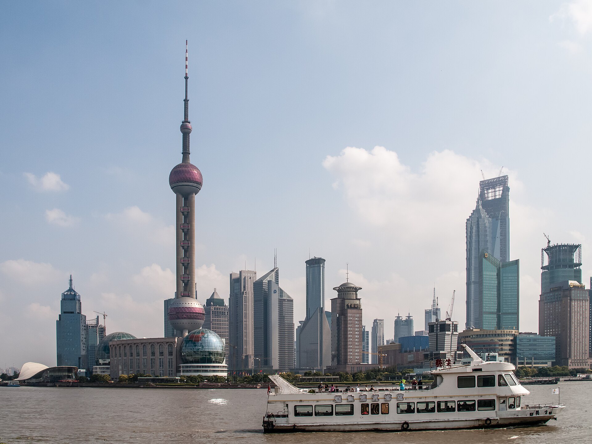 A passenger ferry crossing the Huangpu with the Pudong towers behind it