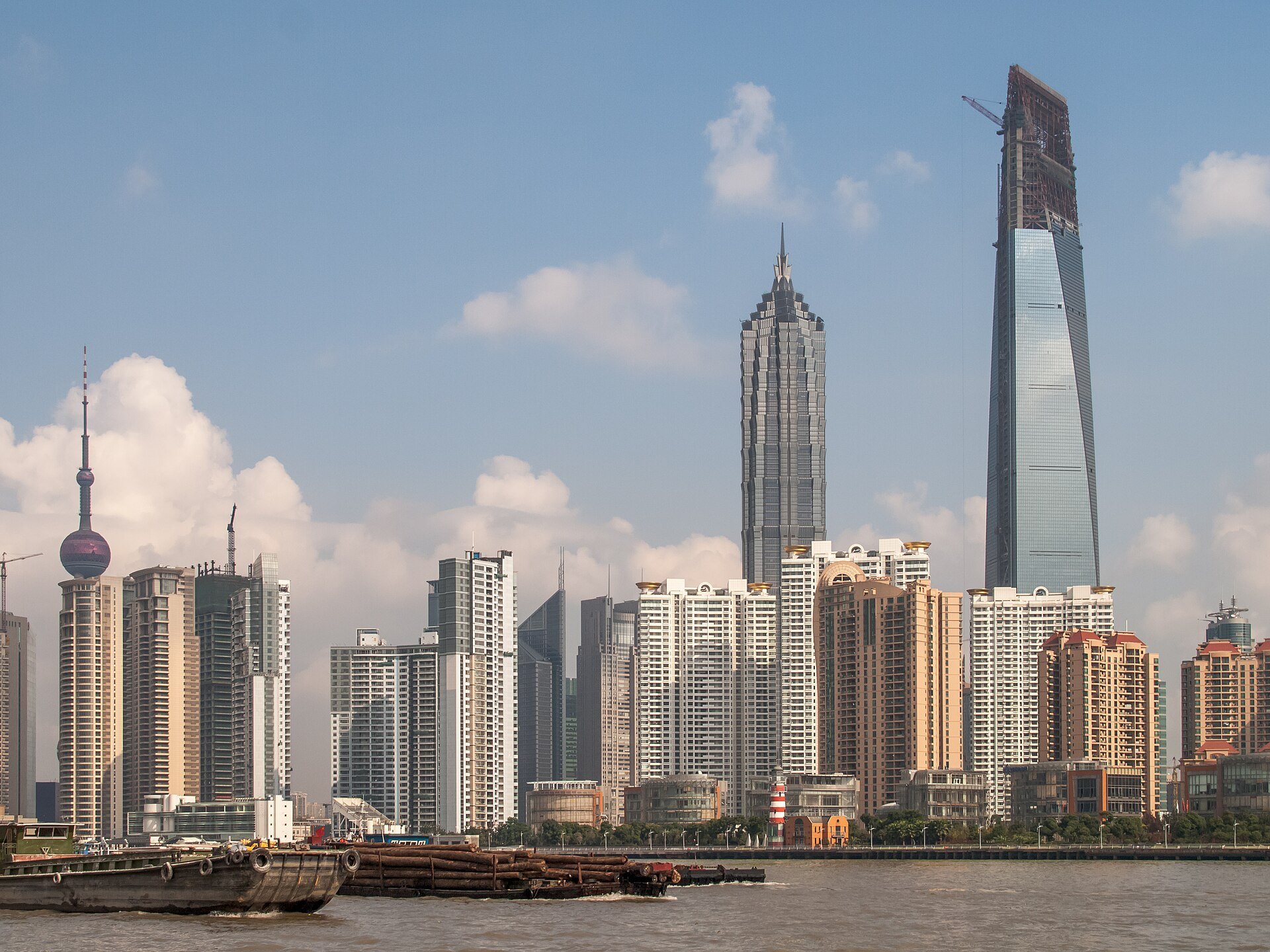 The towers of Lujiazui rising above the river on a clear day