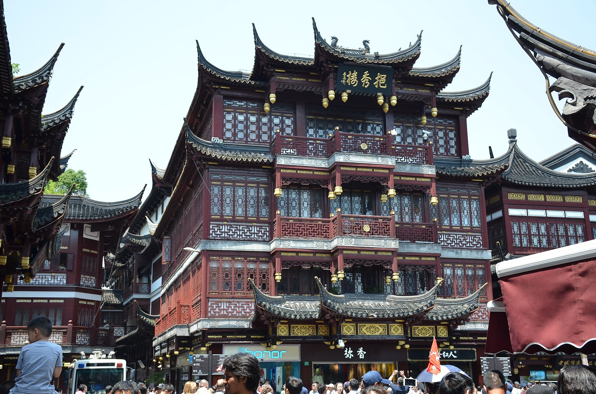The carved timber facades of the bazaar buildings around the garden